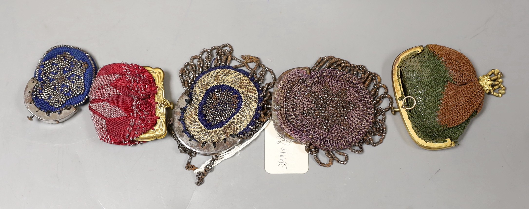 Five 19th century miniature cut steel purses, together with other mixed cut steel and knitted purses